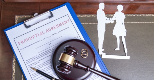 prenuptial agreement with paper cutout of couple